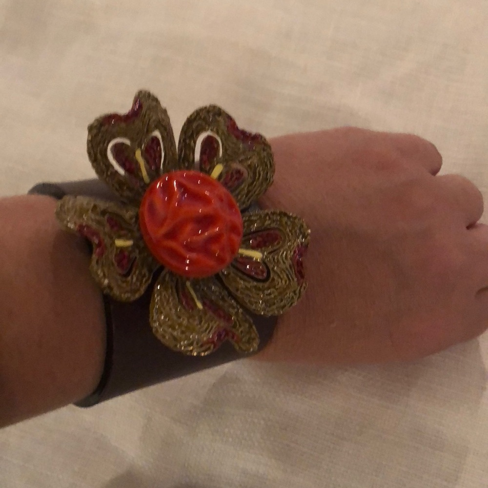 Leather cuff with floral brooch